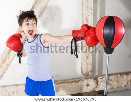 young boy with red boxing gloves