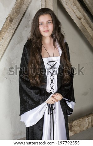 young woman dressed as a princess looking sad