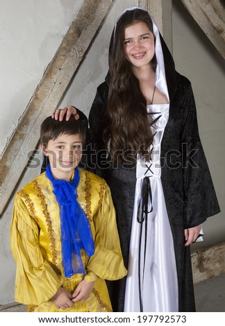 young girl with braces dressed as princess and little boy dressed as prince