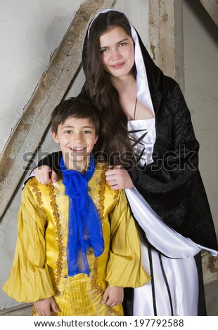 young girl dressed as princess and little boy dressed as prince