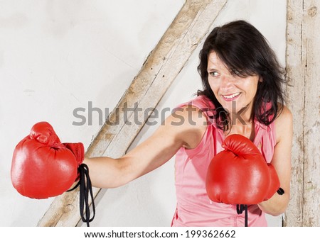 brunette woman with red boxing gloves and a big smile