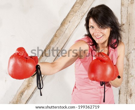 brunette woman with red boxing gloves