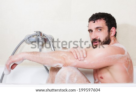 latin man relaxes in a bathtub
