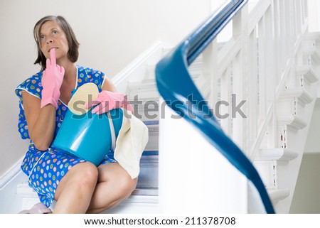 cleaning lady sitting on stairs and having a break