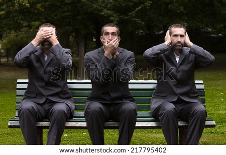 businessman sitting on a bench three times covering his ears,eyes and mouth