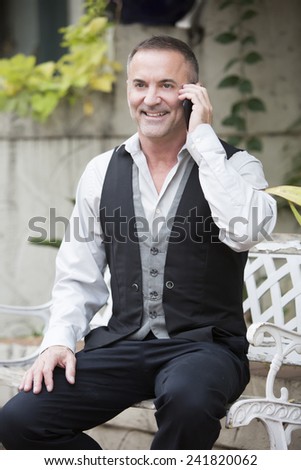 businessman sitting outside talking on the phone