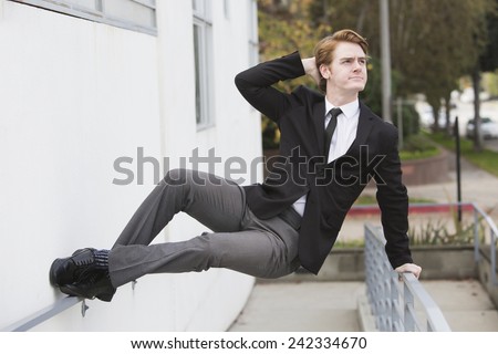 man in a suit jumping at a wall