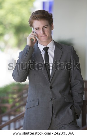 businessman standing outside talking on the phone