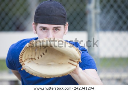 young man with baseball glove on a sports field
