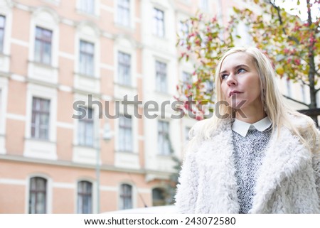 blond woman on street looking sad