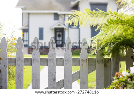 white picket fence and an entrance of a home