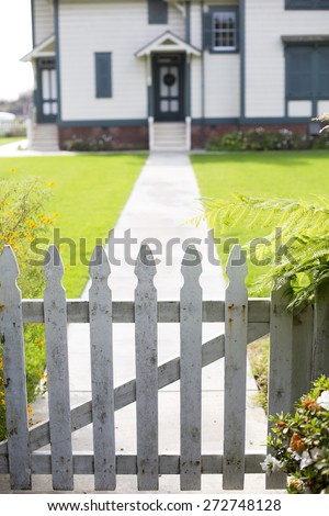 white picket fence and an entrance of a home