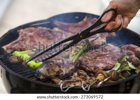 smoking barbecue with meat and vegetables