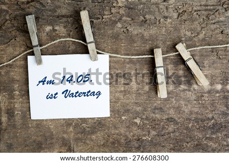 sign on a clothes line with german text:Am 14.05. ist Vatertag (fathers day is on 14.05.)