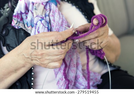 close-up of senior knitting hands