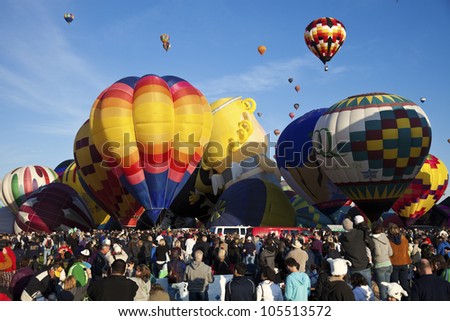 ALBUQUERQUE, NM - OCTOBER 02: Hot Air Balloon Fiesta in Albuquerque, New Mexico. Crowd of the visitors observing the ascending balloons during clear fall morning on October 2, 2011.