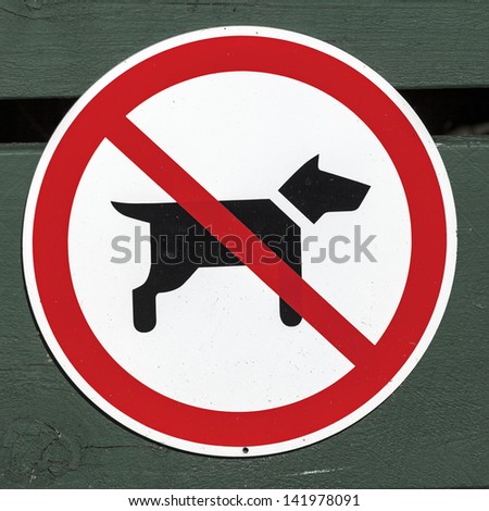 No dogs sign seen on the green wooden fence