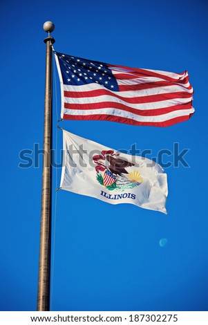 US and Illinois flags against blue sky