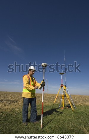 Land surveyor working with GPS unit
