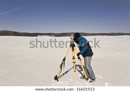 Winter land surveying - measurements with total station.