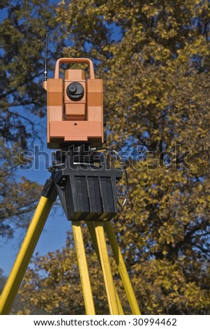Theodolite against a tree - fall land surveying.