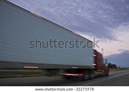 Semi Truck driving at sunset