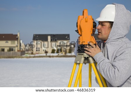 Land surveying during the winter - suburban area.