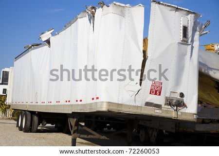White trailer after accident against blue sky.