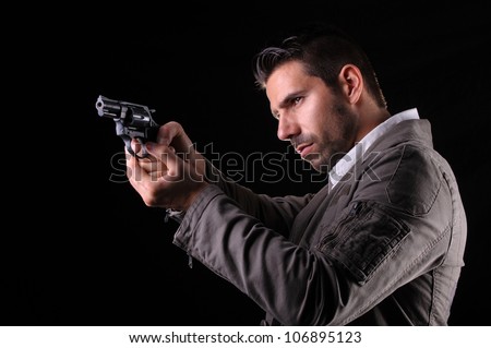 Gangster or private security or detective with a gun aiming