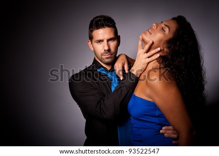 a couple with the man in a dominating position taking control in a sexy way