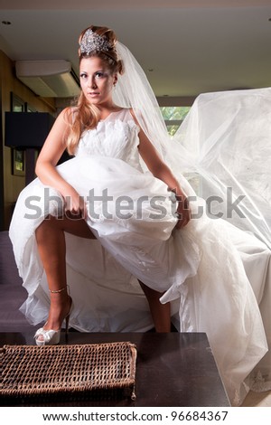 blonde bride with very big veil and tiara in strong pose