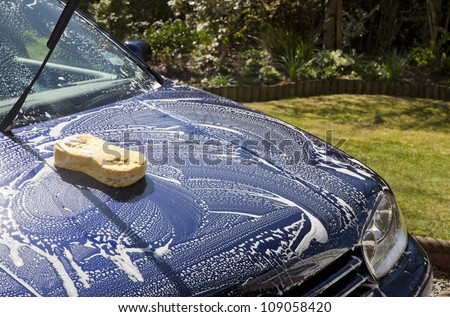 cleaning a car with soapy water and a sponge, exterior car valet