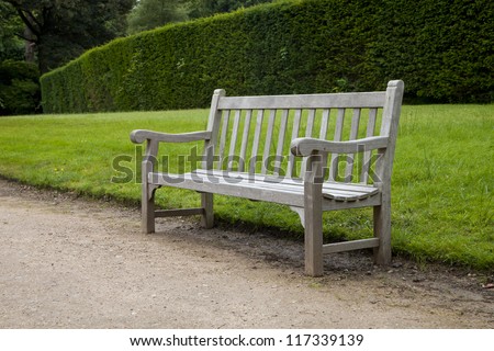 park bench on a path with grass