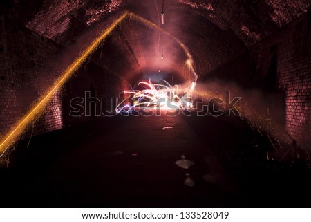 firework explosion inside a dark tunnel at night