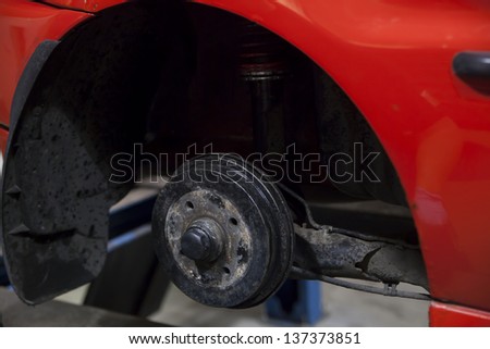 red car in garage getting repaired