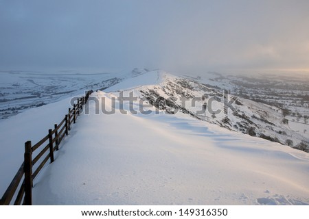 beautiful winter scene at sunrise, fence and snow