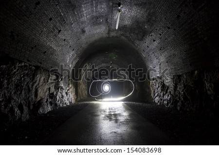 light painting in a dark tunnel