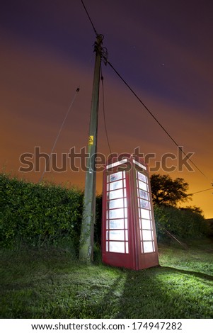 traditional red british phone box at night