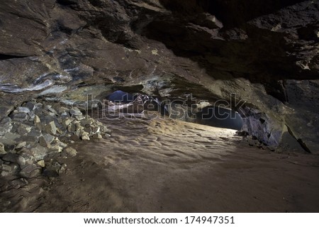 underground mine / cave lit with torches, alderley edge