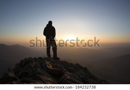 silhouette of man at sunrise in the mountains