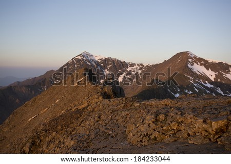 mountain path in the morning sun light with snow on the summit, snowdon, crib goch
