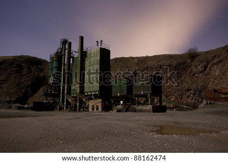 Old abandoned industrial works at night created using a long exposure