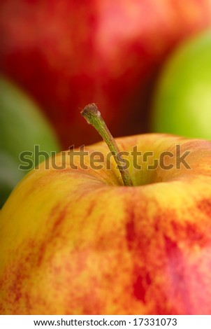 Four apples - red, yellow and green, vertical crop