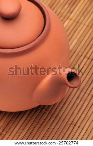 Ceramic teapot on a bamboo mat