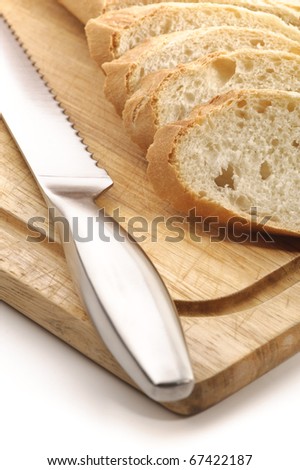 Sliced white bread on a wood cutting board, white background