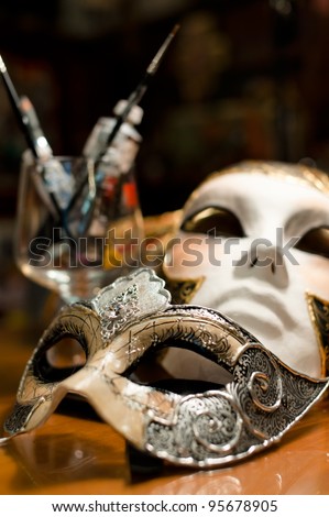 Still-life with two venice carnival masks, paints and brushes