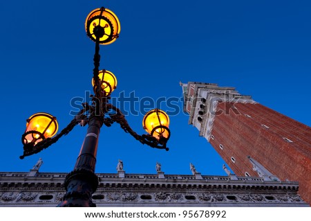 Morning at San Marco square. Campanile San Marco, National Library building and famous Venetian street-lamp.