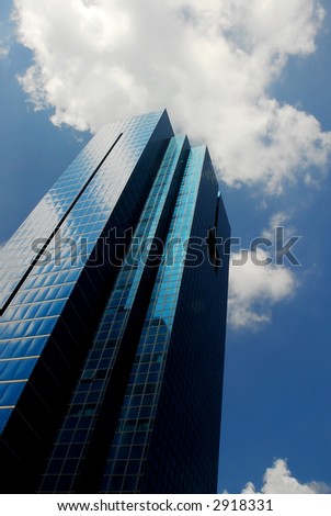 big skyscraper in singapore with cloudy sky