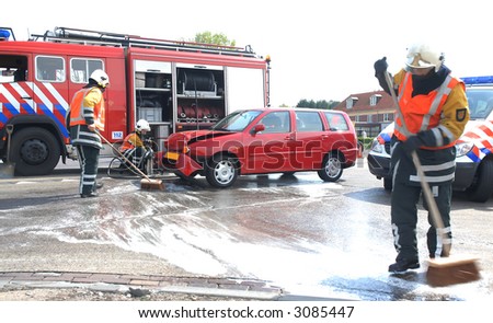 firemen cleaning the street after a car-crash