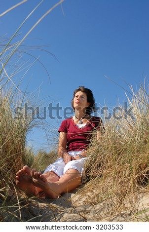 girl day dreaming at the beach on a sunny day